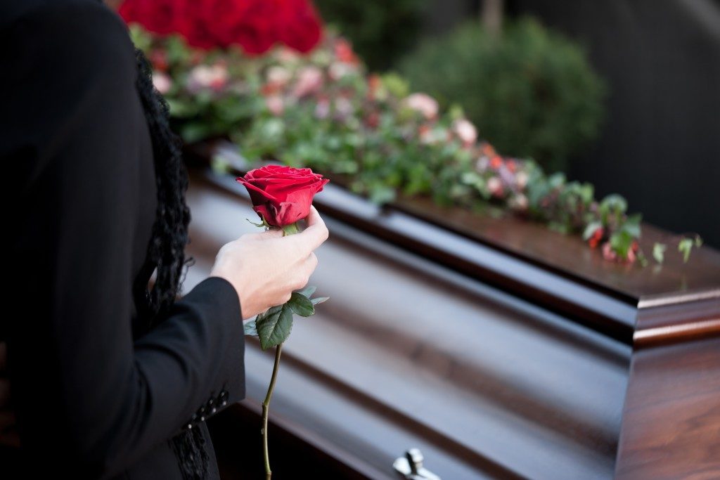 Woman holding rose in a funeral