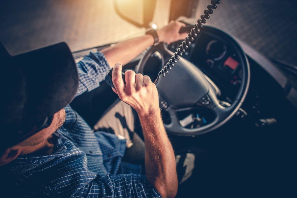 Man talking on the radio while driving a truck