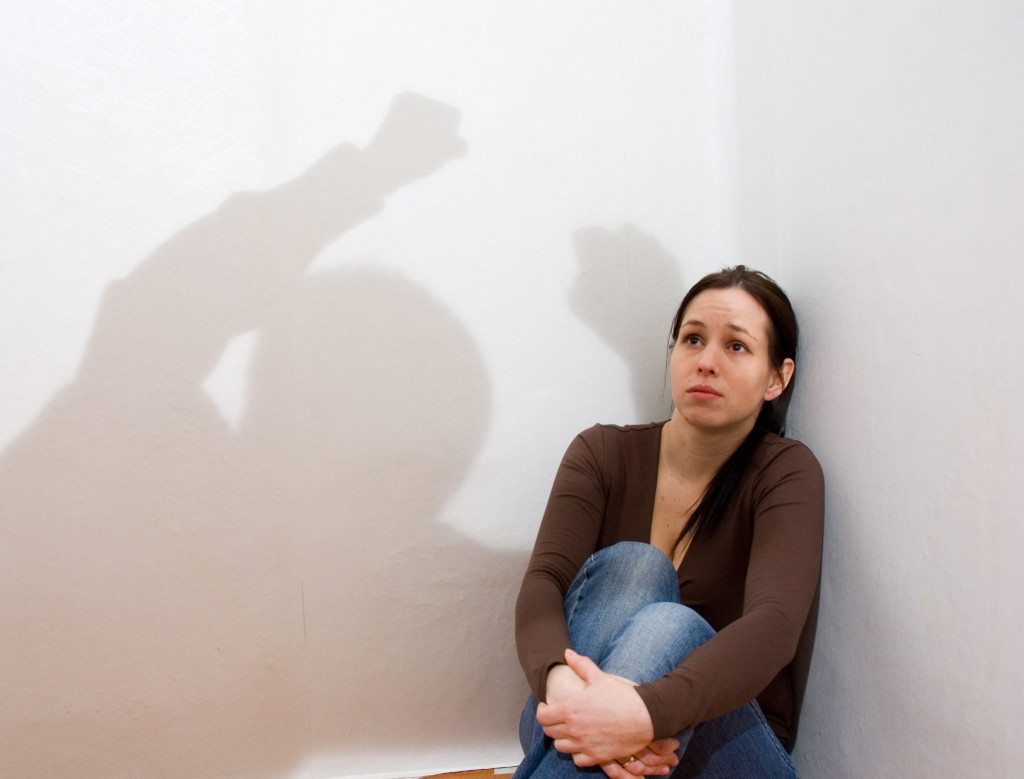 woman sitting in a corner