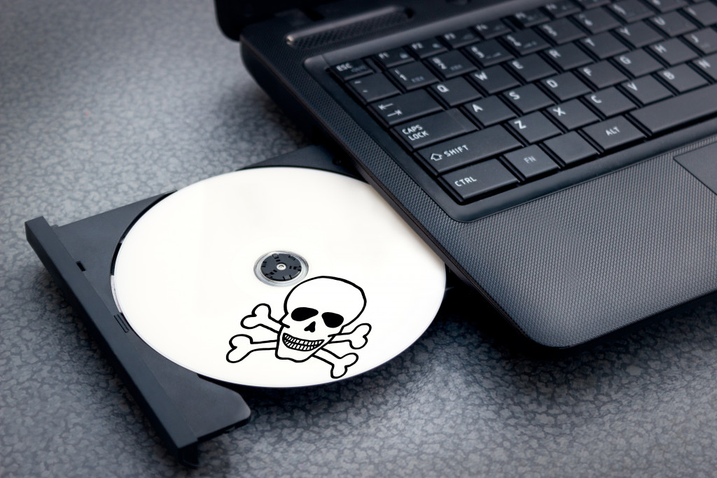 pirated CD being inserted in a laptop