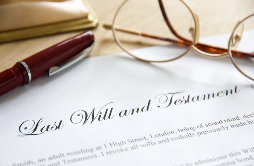 A last will and testament document with pen and eyeglasses